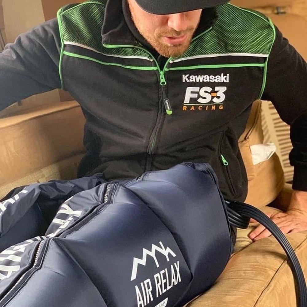 AIR RELAX PLUS AR-3.0 BODY PACKAGE SYSTEM — Man wearing recovery shorts sitting on a couch